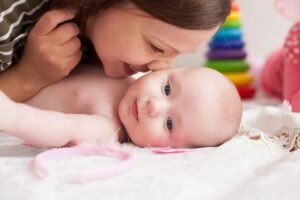 Tender moment between mother and baby with a warm and cozy atmosphere.